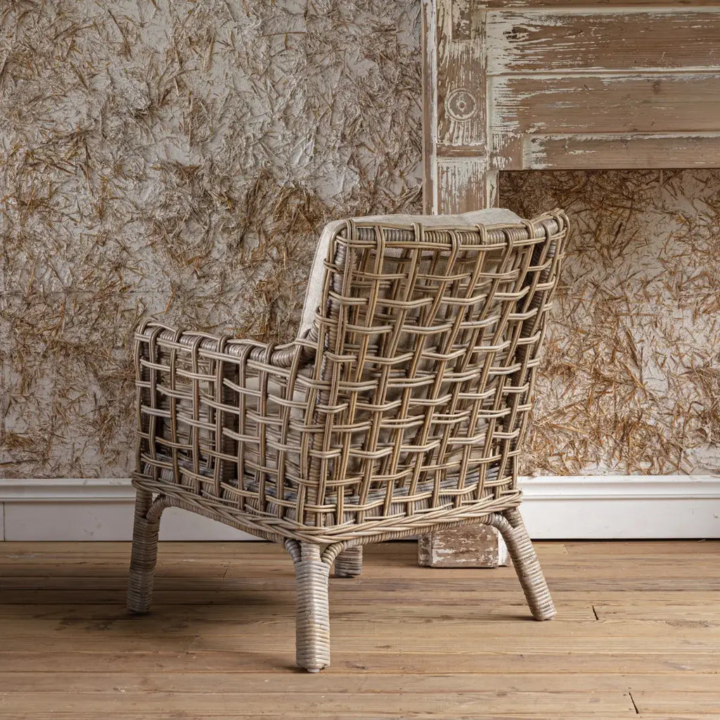 Poltrona in Rattan - Misure 28.25"L x 31.5"P x 31.5"A - Questa poltrona porta il fascino rilassato di un cottage, con la sua trama ariosa e i morbidi cuscini neutri, perfetta